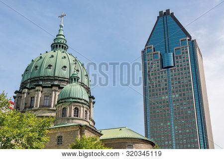 Montreal, Canada - 03 September 2019: La Gauchetiere Building & Mary, Queen Of The World Cathedral
