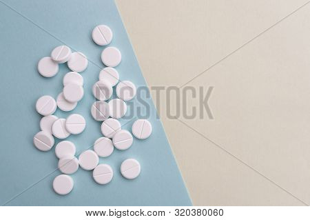 Pills Lie On A Light Blue Background. Healthcare And Medicine Concept