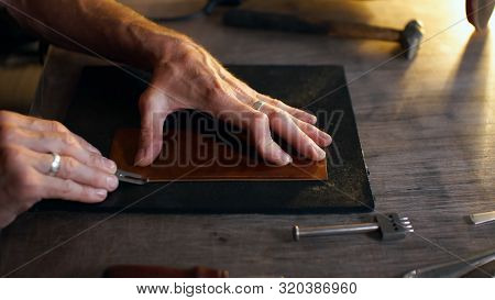 Man Holding Crafting Tool And Working.