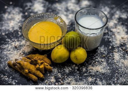 Lemon Face Mask On The Wooden Surface Consisting Lemon Juice, Gram Flour Or Chickpea Flour, Turmeric