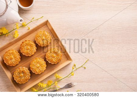Mid-autumn Festival Holiday Concept Design Of Moon Cake, Mooncakes, Tea Set On Bright Wooden Table W