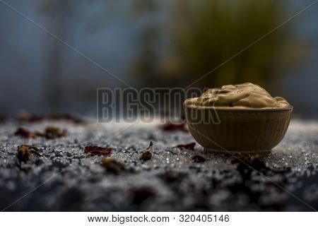 Ubtan/face Mask/face Pack Of Multani Mitti Or Fuller's Earth On Wooden Surface In A Glass Bowl Consi