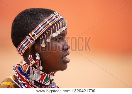 Masai Mara, Kenya - August, 2019: The Masai Woman Portrait Near Entrance Of Masai Mara National Rese