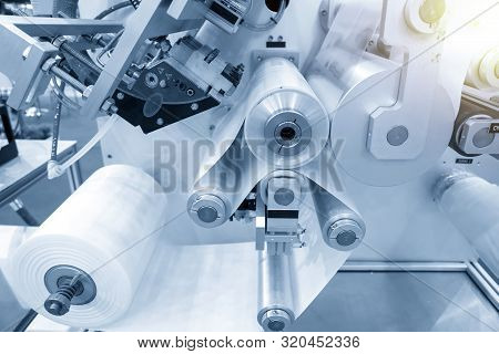 The Operation Of Automatic Plastic Bag Production Machine With Lighting Effect. Close-up Of The Roll