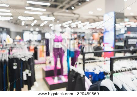 Blurred Woman Sports And Fitness Clothing Merchandise Store. Blurred Image Interior Of Sports And Fi