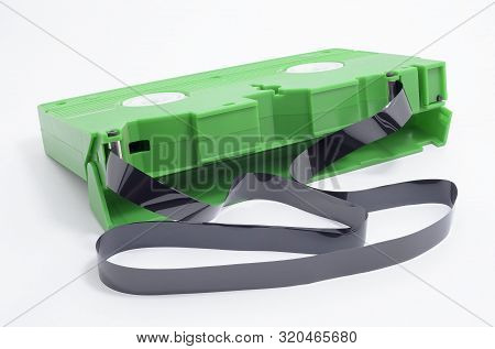Vhs Tape With Open Cover And The Magnetic Tape Rolled Out Of The Spool, Out Of The Tape. Green Vhs, 