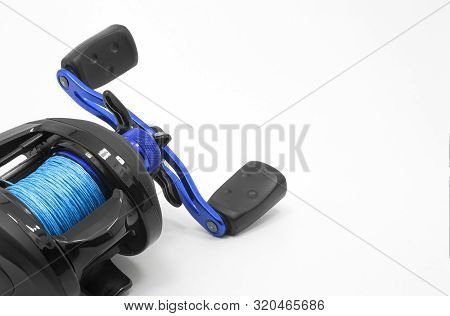 Fishing Gear. Baitcast Fishing Reel On A White Background With Space For Text.