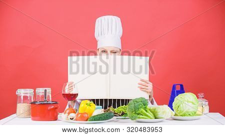 She Is A Super Cook. Lady Cook Looking For Cooking Recipe In Cookbook. Pretty Woman Reading Cook Boo