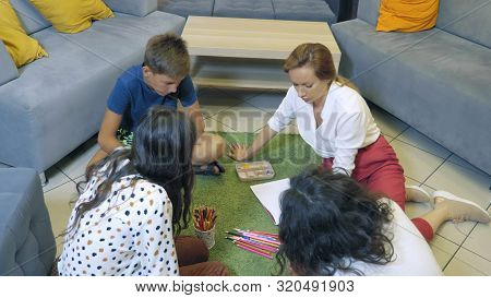 The Concept Of Childrens Group Psychotherapy. Female Psychologist Conducts A Group Consultation With