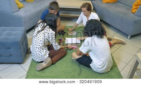 The Concept Of Childrens Group Psychotherapy. Female Psychologist Conducts A Group Consultation With