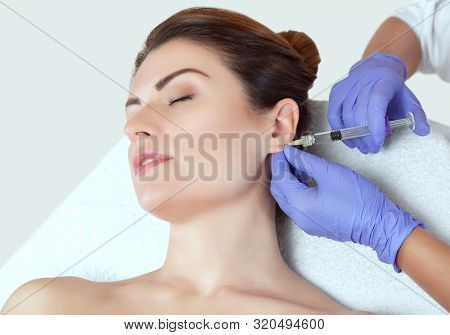The Doctor Cosmetologist Makes The Injections Procedure For Smoothing Wrinkles And Against Flabbines