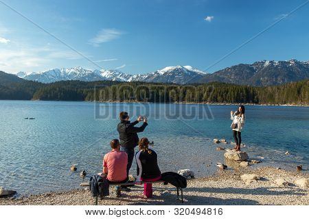 Eibsee, Germany, March 31, 2019: Husband Taking Selfie Of His Wife For Instagram At Eibsee
