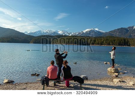 Eibsee, Germany, March 31, 2019: Husband Taking Selfie Of His Wife For Instagram At Eibsee