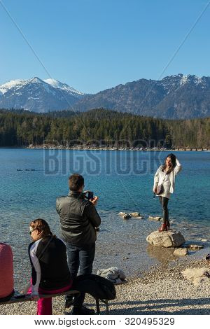 Eibsee, Germany, March 31, 2019: Husband Taking Selfie Of His Wife For Instagram At Eibsee