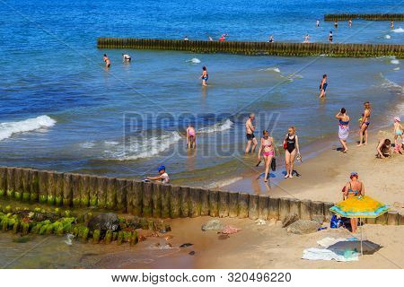 Zelenogradsk, Kaliningrad Region, Russia - June 18, 2019: Unknown People Resting On A Sandy Beach On