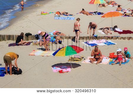 Zelenogradsk, Kaliningrad Region, Russia - June 18, 2019: Unknown People Sunbathing On The Sand Beac