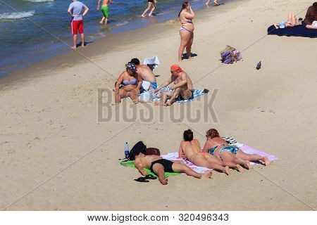 Zelenogradsk, Kaliningrad Region, Russia - June 18, 2019: Unknown People Sunbathing On The Sand Beac