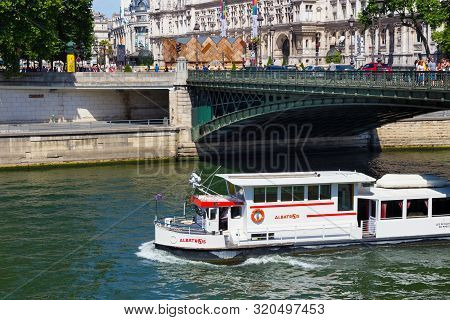 Paris, France - June 23, 2017: White Tourist Boat Under Pont D Arcole Bridge On The Seine River In T