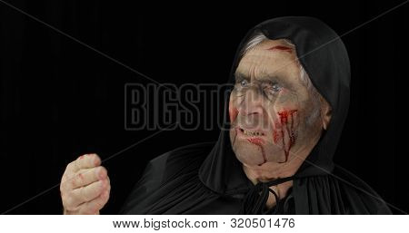 Old Executioner Halloween Man Portrait. Elderly Man With Dripping Blood On His Face. Executioner, He