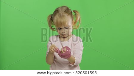 Child Having Fun Making Ping Slime. Kid Playing With Hand Made Toy Slime. Funny Kid Girl. Relax And 