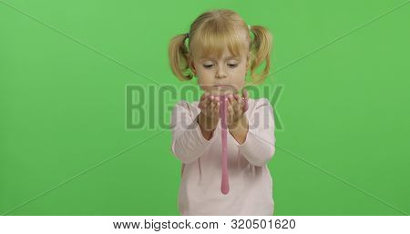 Child Having Fun Making Ping Slime. Kid Playing With Hand Made Toy Slime. Funny Kid Girl. Relax And 