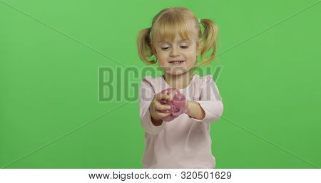 Child Having Fun Making Ping Slime. Kid Playing With Hand Made Toy Slime. Funny Kid Girl. Relax And 