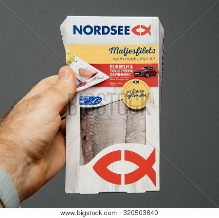 Paris, France - Aug 19, 2019: Man Hand Holding Delicious Nordsee Matjesfilets Fish In The Nordic Cui