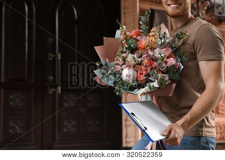 Delivery Man With Beautiful Flower Bouquet Outdoors, Closeup
