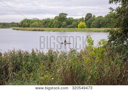 City Carnikava, Latvian Republic. Fisherman Catching Fish In The River, Nature, Silence And Water Wa