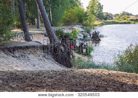 City Carnikava, Latvian Republic. Fisherman Catching Fish In The River, Nature, Silence And Water Wa
