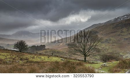 Beautiful Winter Landscape Image Looking Along Valley From Crimpiau Towards Mount Snowdon In The Dis