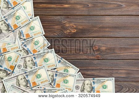 Top View Banknotes On Colored Desk With Copy Space On Top. One Hundred Dollar Bills With Stack Of Mo