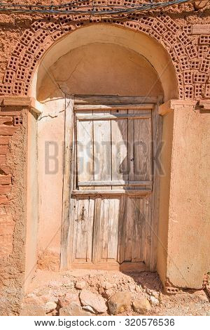 Ancient Wooden Door Of House Built With Bricks And Adobe