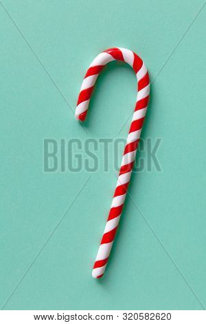 Christmas Peppermint Candy Cane On Pastel Turquoise Background. Festive Minimal Style Flat Lay. For 