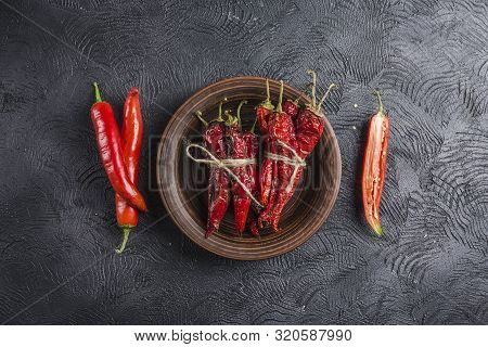 Spicy Chili On A Dark Background In Ceramic Plates, Flatlay. Used As An Ingredient For Harissa, Ajik