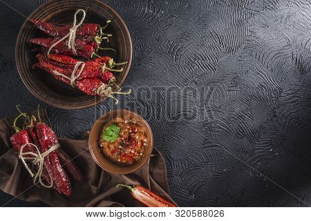 Spicy Chili On A Dark Background In Ceramic Plates, Flatlay. Used As An Ingredient For Harissa, Ajik