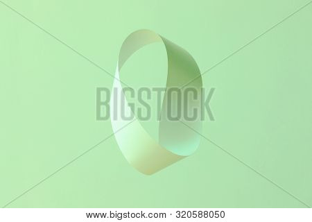 Mobius Strip Made From Paper Soaring In The Air On Mint Background. Trendy Surreal Airy Image. Abstr