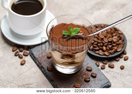 Portion Of Classic Tiramisu Dessert In A Glass Cup On Stone Serving Board And Fres Espresso Coffee O