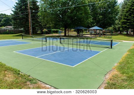 Recreational Sport Of Pickleball Court In Michigan, Usa Looking At An Empty Blue And Green New Court