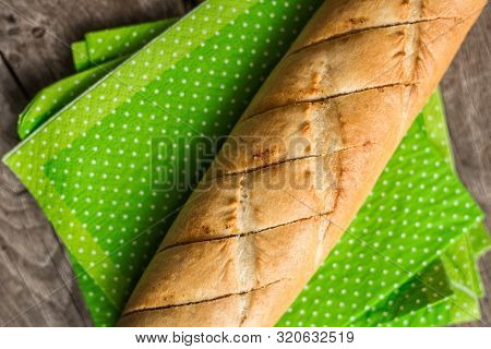 Sliced long french bread over wooden table. Baguette. Restaurant