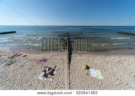 Breakwater On Beach. Beautiful Seascape. Wooden Sea Separator. Protection Holidaymakers From Effects