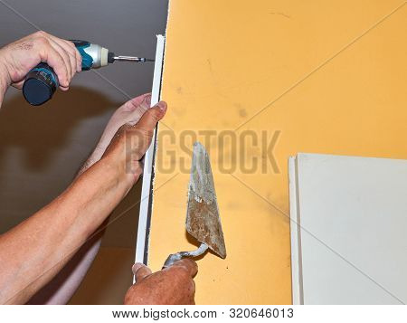 Attaching A Part Of A Plaster Board On A Wall