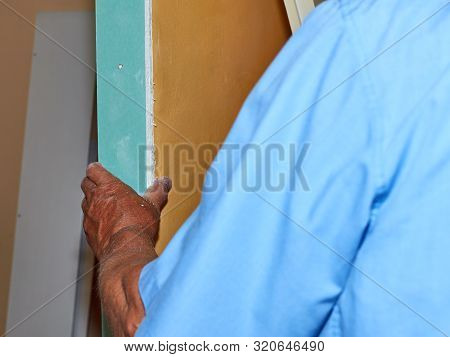 Hand Attaching A Part Of A Plaster Board