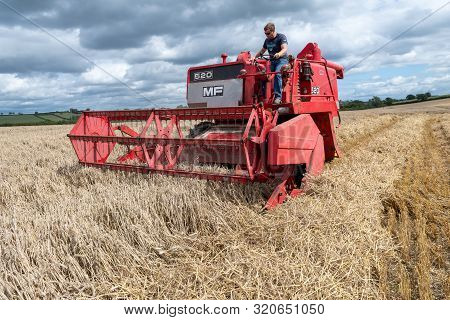 Haselbury Plucknett.somerset.united Kingdom.august 18th 2019.a Vintage Combine Harvester Is Harvesti
