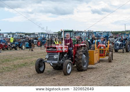 Haselbury Plucknett.somerset.united Kingdom.august 18th 2019.vintage Tractors Are Being Driven At A 
