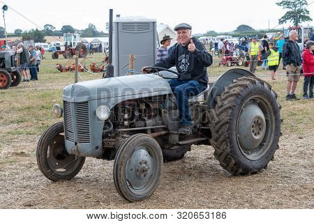 Haselbury Plucknett.somerset.united Kingdom.august 18th 2019.a Massey F|erguson T20 Is Being Driven 