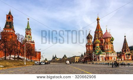 Moscow, Russia, April 2013 Tourists Visiting St Basils Cathedral, Beautiful Spasskaya Tower And The 