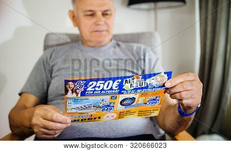 Paris, France - May 22, 2019: Senior Serious Man Holding Flyer Advertising Featuring On The Cover Mu