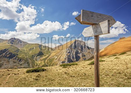 Wooden trail signs on Shara Mountains