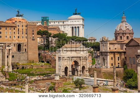 Rome, Italy - April, 2018: Tourists Visiting The Roman Forum And The Basilica Of Maxentius And Const